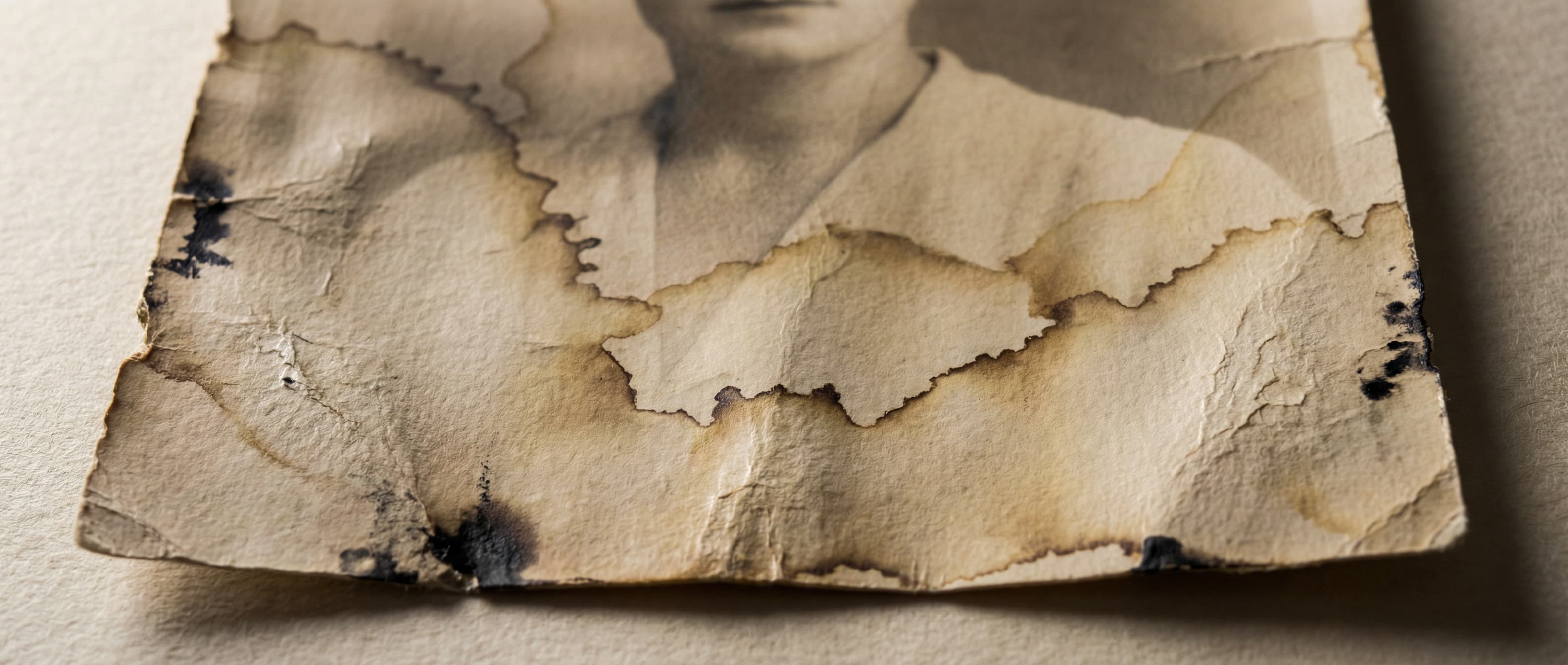Water-stained photograph showing tideline marks and discoloration from moisture damage